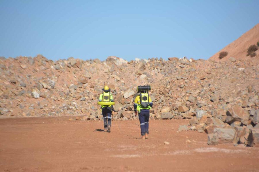 Two operators towing the Loupe TEM system across a mine bench